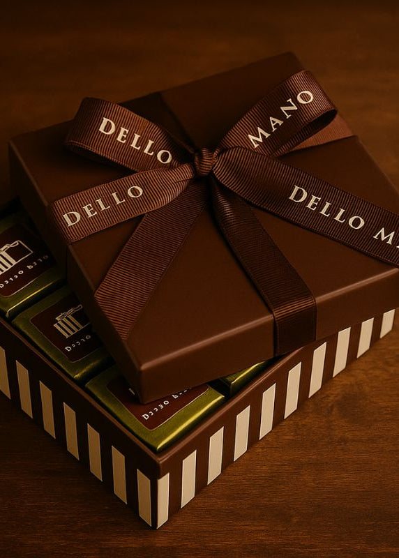 Chocolate gift box with 'Dello Mano' ribbon on a brown background