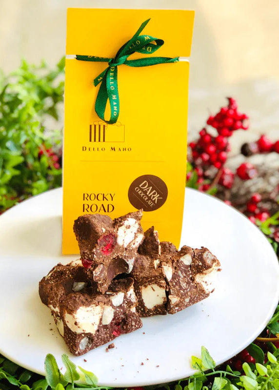 Chocolate Rocky Road on a plate with a yellow Dello Mano packaging in the background.