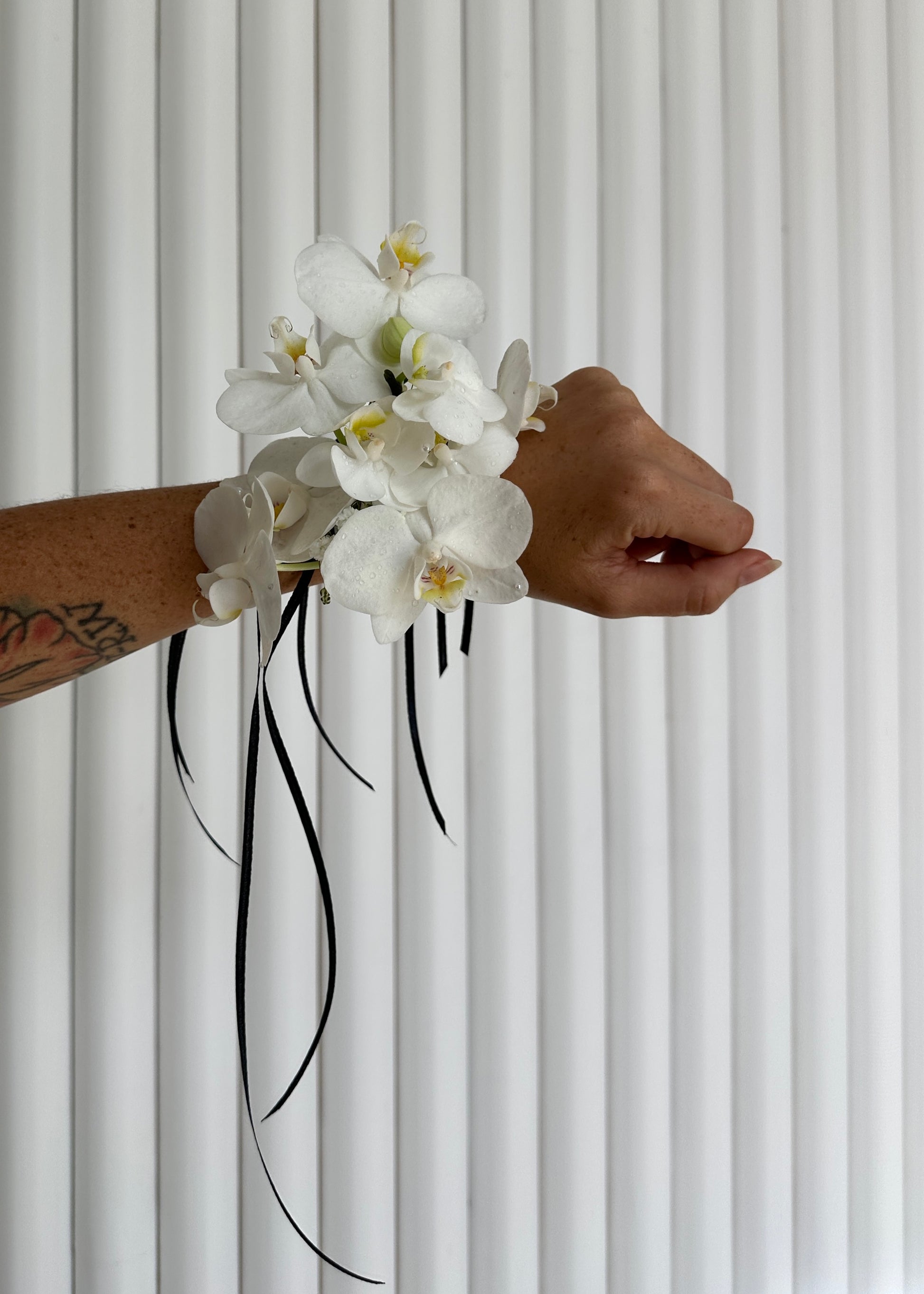 White Orchid Corsage worn on wrist.